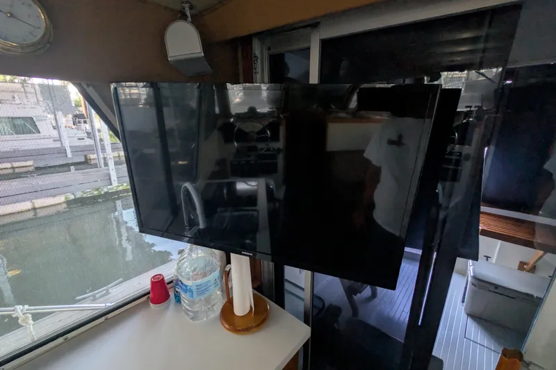 Slide: The Image of Interior of 1975 Tollycraft 37 Sedan with mounted TV and water bottle. - 28