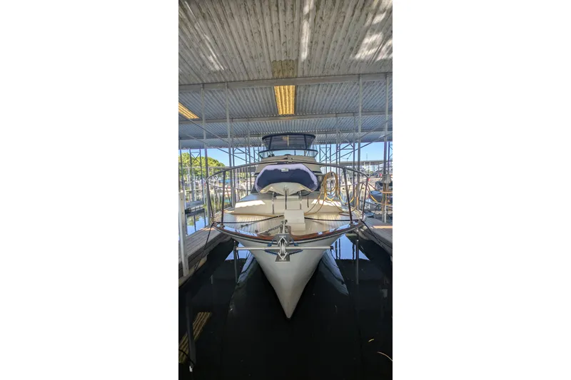 Slide: The Image of 1975 Tollycraft 37 Sedan yacht docked in a covered marina. - 3