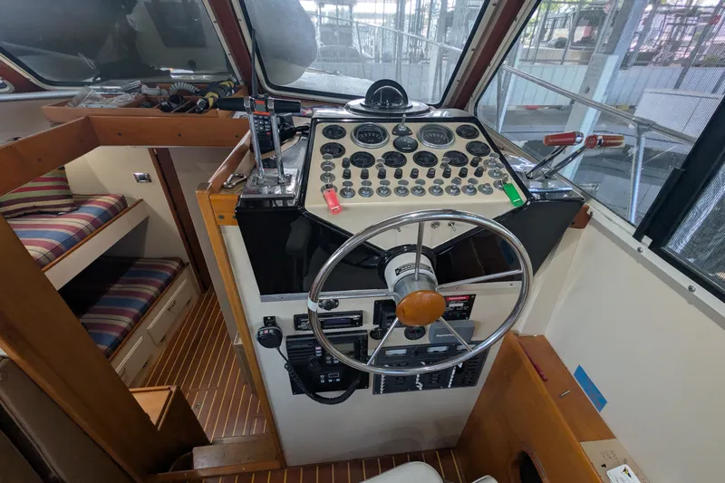 Slide: The Image of 1975 Tollycraft 37 Sedan helm with vintage controls and striped seating. - 30