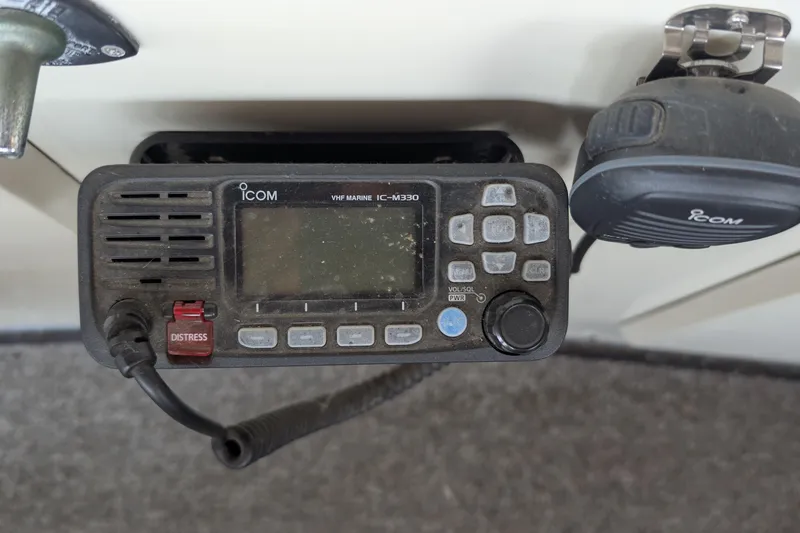 Slide: The Image of VHF marine radio on 1975 Tollycraft 37 Sedan, featuring distress button and microphone. - 35