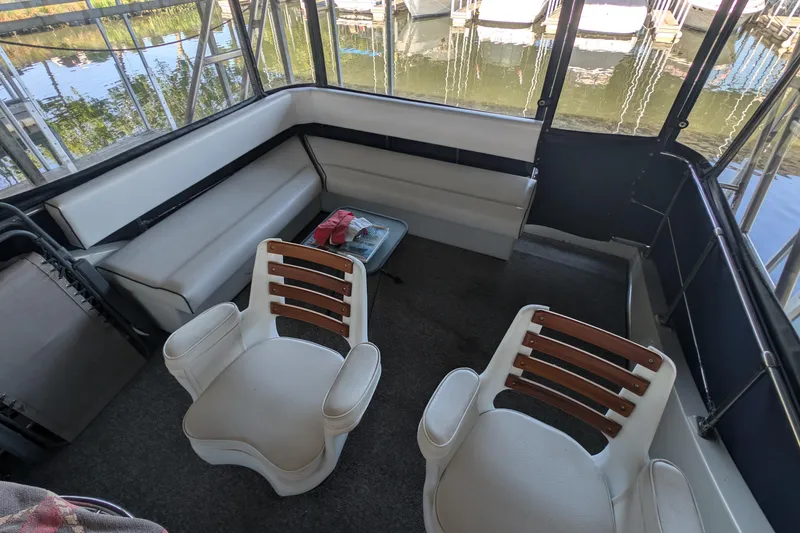 Slide: The Image of Interior of a 1975 Tollycraft 37 Sedan boat with seating and table. - 37