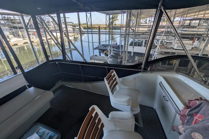 Slide: The Image of 1975 Tollycraft 37 Sedan interior with seating, docked at marina. - 38