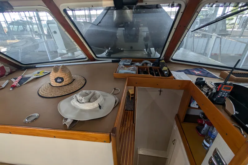 Slide: The Image of Interior view of a 1975 Tollycraft 37 Sedan boat with hats and navigation equipment. - 39