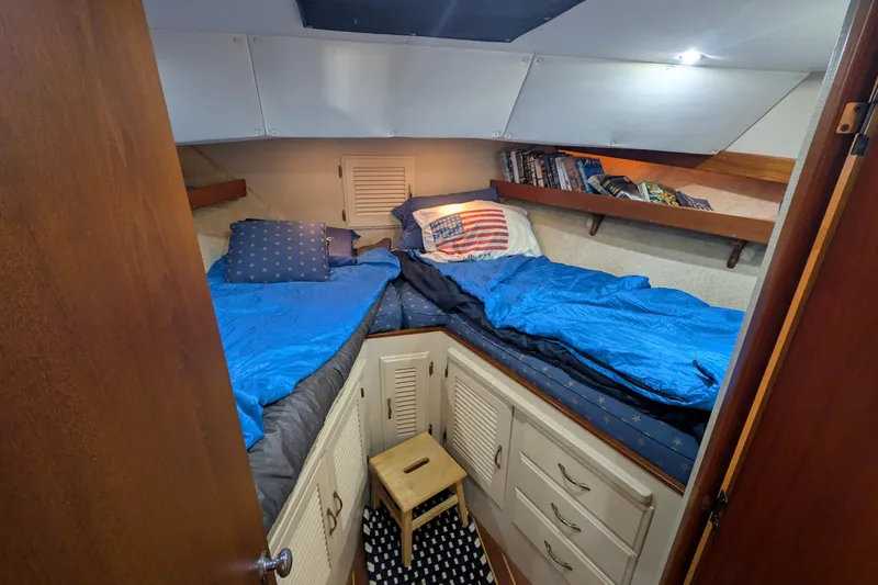 Slide: The Image of Cozy cabin interior of 1975 Tollycraft 37 Sedan with twin beds and storage. - 43