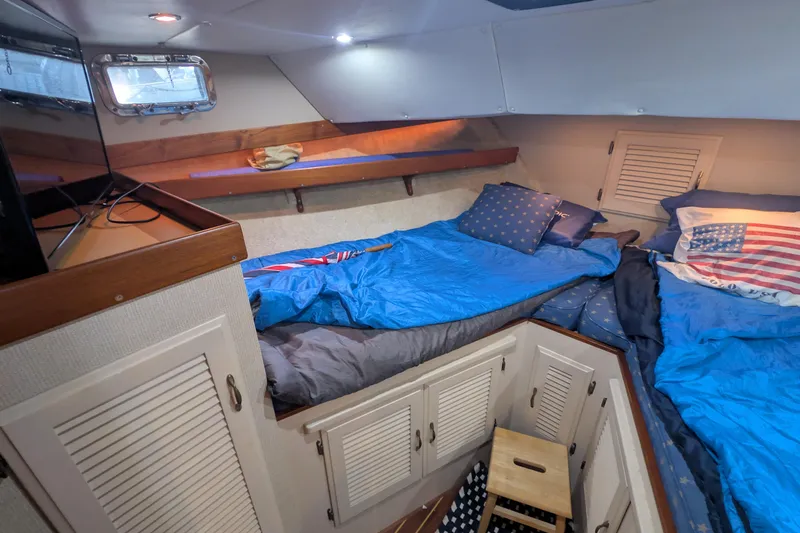 Slide: The Image of Cozy cabin interior of a 1975 Tollycraft 37 Sedan with twin beds and nautical decor. - 44