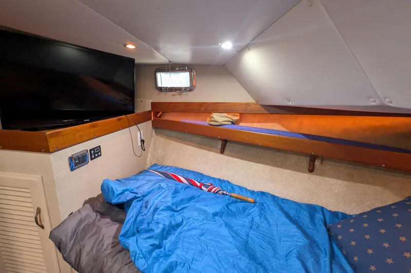 Slide: The Image of Cozy cabin interior of 1975 Tollycraft 37 Sedan with bed, TV, and porthole window. - 45