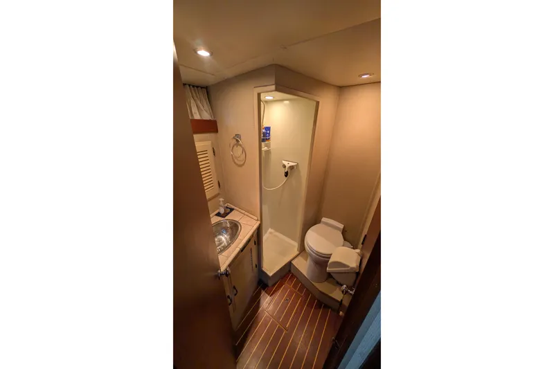 Slide: The Image of 1975 Tollycraft 37 Sedan bathroom with shower, sink, and toilet. - 46