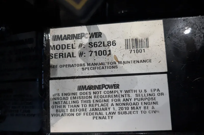Slide: The Image of Label on MarinePower engine, model S62L86, serial 71001, with emission compliance notice. - 51