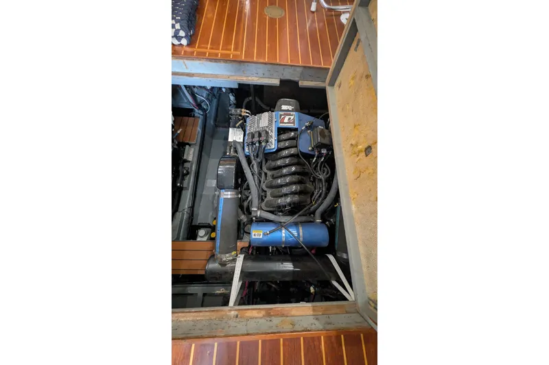 Slide: The Image of Engine compartment of a 1975 Tollycraft 37 Sedan boat, showcasing detailed mechanical components. - 53