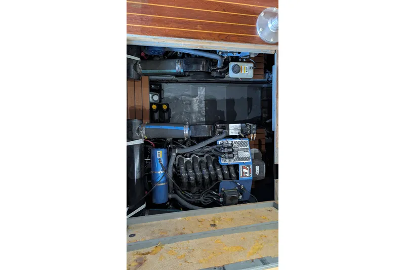 Slide: The Image of Engine compartment of a 1975 Tollycraft 37 Sedan boat, showcasing mechanical components. - 54