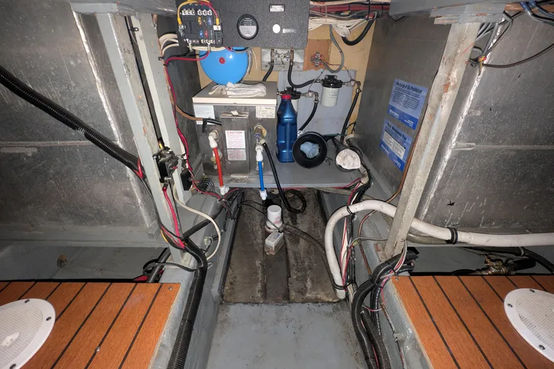 Slide: The Image of Engine room of a 1975 Tollycraft 37 Sedan boat, showcasing wiring and equipment. - 56