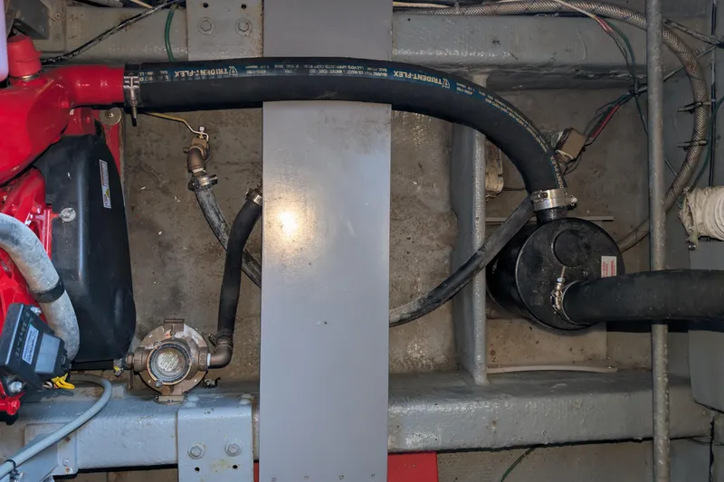 Slide: The Image of Engine compartment of a 1975 Tollycraft 37 Sedan with hoses and mechanical components. - 61