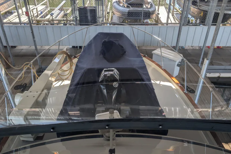 Slide: The Image of 1975 Tollycraft 37 Sedan boat docked in a marina, covered and secured. - 65
