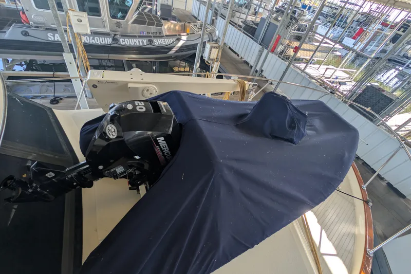 Slide: The Image of 1975 Tollycraft 37 Sedan with covered outboard motor in marina setting. - 66