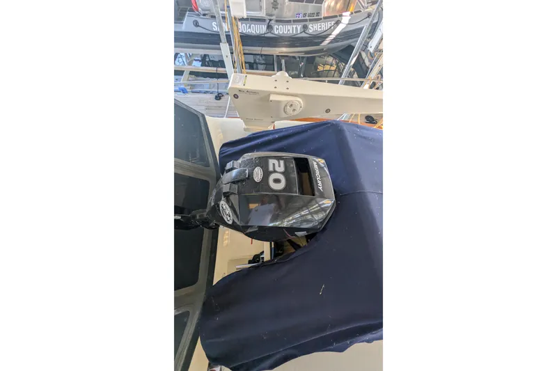 Slide: The Image of 1975 Tollycraft 37 Sedan with Mercury outboard motor, docked near sheriff's boat. - 68