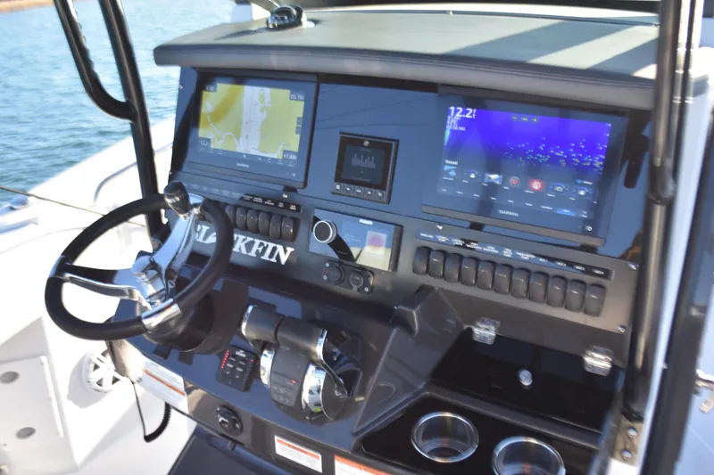 Slide: The Image of 2022 Blackfin 272 CC boat dashboard with navigation screens and controls. - 18