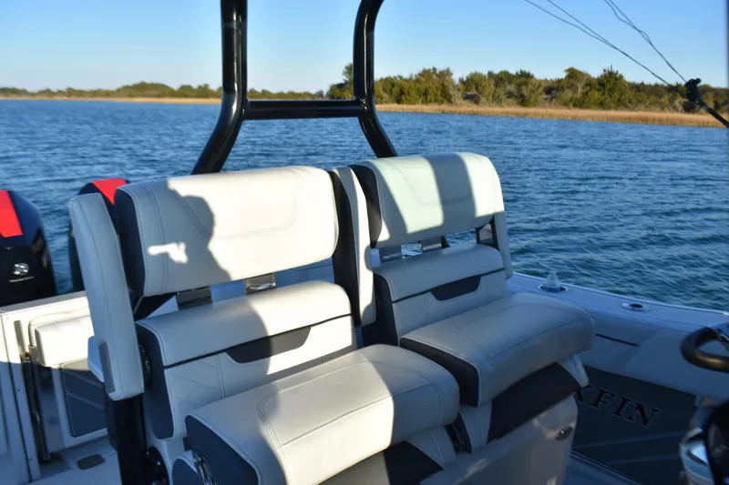 Slide: The Image of 2022 Blackfin 272 CC boat interior with white seating on a sunny day. - 20