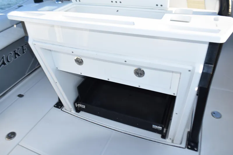 Slide: The Image of 2022 Blackfin 272 CC boat storage compartment with drawers and open space. - 23