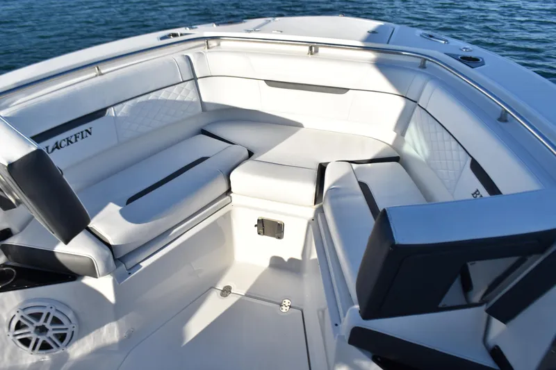 Slide: The Image of 2022 Blackfin 272 CC boat interior with white seating and ocean backdrop. - 8