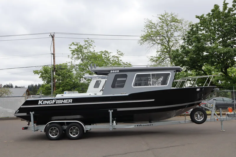 The Image of 2026 KingFisher 2825 Coastal Express boat on trailer, parked outdoors. - 1