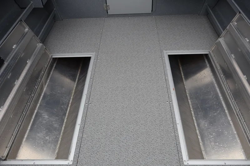 Slide: The Image of Interior view of 2026 KingFisher 2825 Coastal Express boat with open storage compartments. - 13