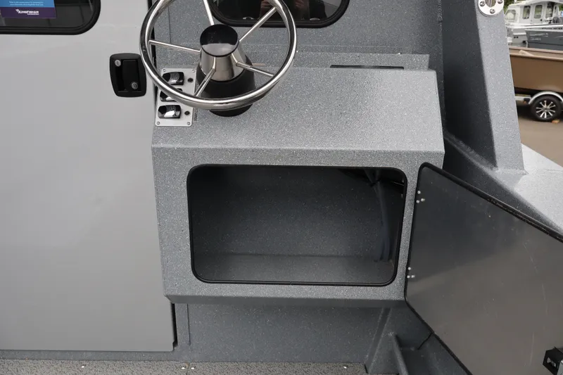 Slide: The Image of Steering console of 2026 KingFisher 2825 Coastal Express boat, featuring a sleek design. - 15