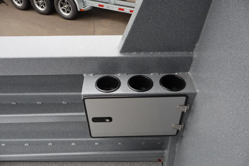 Slide: The Image of Interior detail of 2026 KingFisher 2825 Coastal Express boat with cup holders and storage compartment. - 17