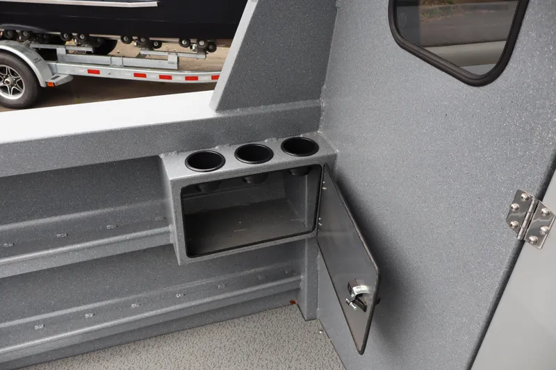 Slide: The Image of Interior of 2026 KingFisher 2825 Coastal Express boat with cup holders and storage compartment. - 18