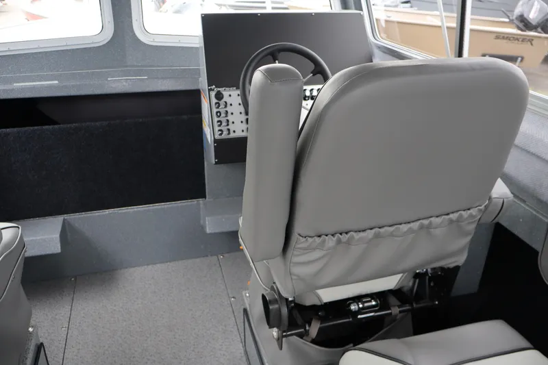 Slide: The Image of Interior of 2026 KingFisher 2825 Coastal Express boat, featuring helm and seating area. - 22