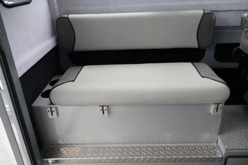 Slide: The Image of Interior seating of 2026 KingFisher 2825 Coastal Express boat, featuring cushioned bench and storage. - 23