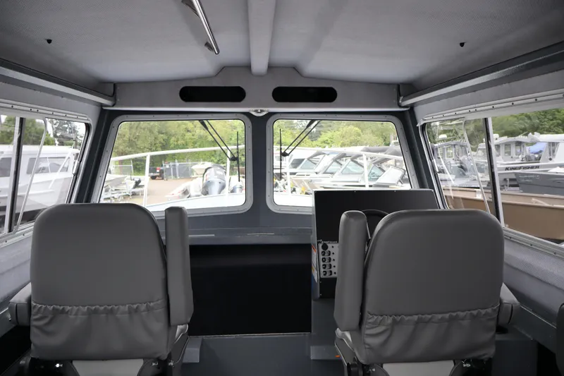 Slide: The Image of Interior view of 2026 KingFisher 2825 Coastal Express boat with dual seats and large windows. - 25