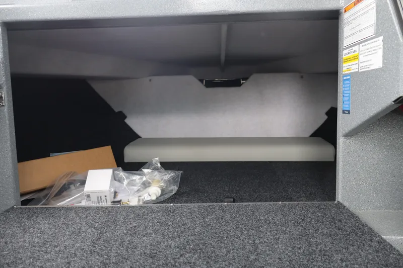 Slide: The Image of Interior storage compartment of 2026 KingFisher 2825 Coastal Express boat, featuring carpeted flooring. - 26