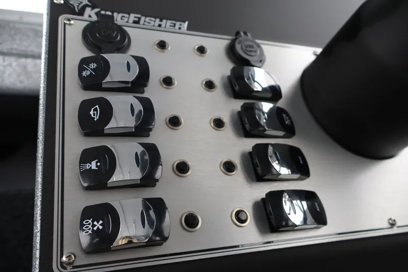 Slide: The Image of Control panel of 2026 KingFisher 2825 Coastal Express boat with labeled switches. - 28