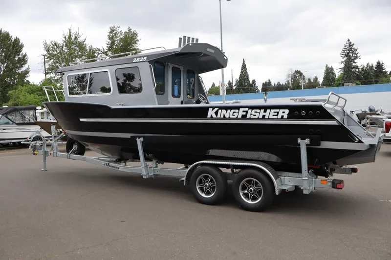 Slide: The Image of 2026 KingFisher 2825 Coastal Express boat on trailer, parked outdoors. - 3