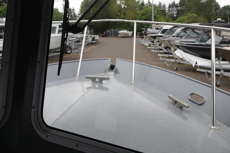 Slide: The Image of 2026 KingFisher 2825 Coastal Express boat view from cabin, docked with other boats. - 30