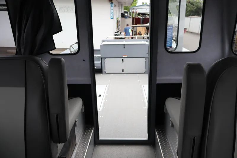 Slide: The Image of Interior view of 2026 KingFisher 2825 Coastal Express boat, showcasing seating and cabin layout. - 31