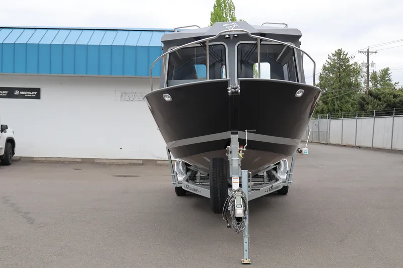 Slide: The Image of 2026 KingFisher 2825 Coastal Express boat on trailer, parked outside dealership. - 4