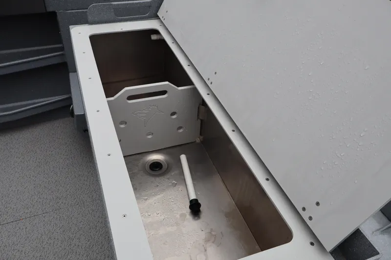 Slide: The Image of Open storage compartment on 2026 KingFisher 2825 Coastal Express boat, showing interior details. - 8
