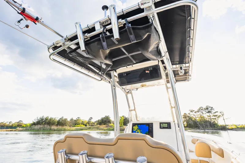 Slide: The Image of 2018 Key West 244 Center Console boat with T-top and navigation system on a serene waterway. - 14