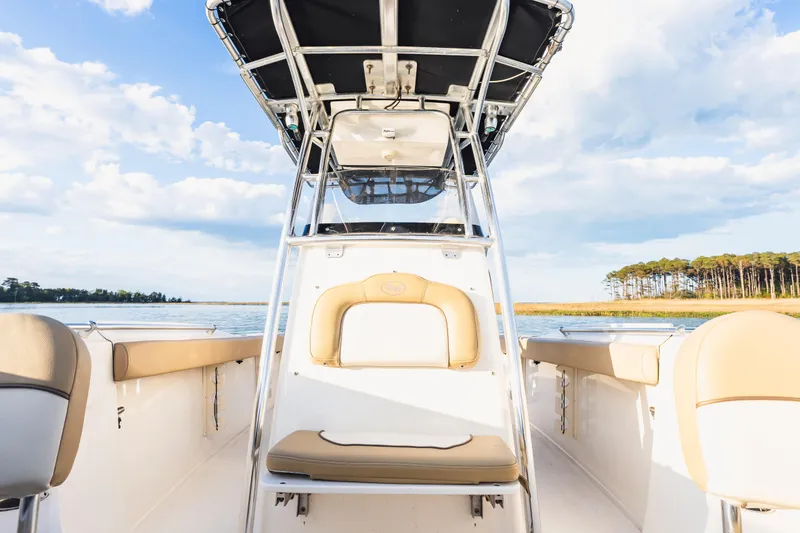 Slide: The Image of 2018 Key West 244 Center Console boat on serene water with clear sky backdrop. - 15