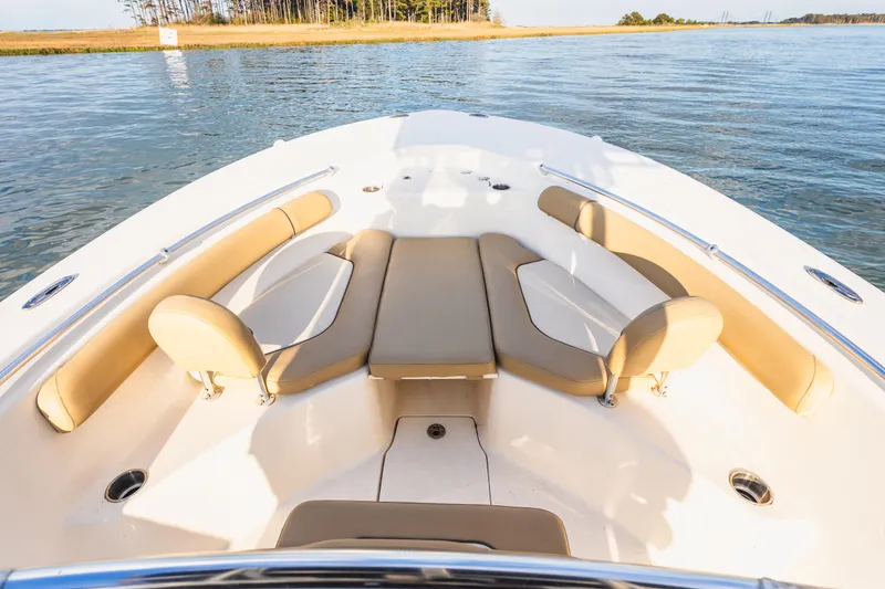 Slide: The Image of 2018 Key West 244 Center Console boat interior with tan seating on calm water. - 16