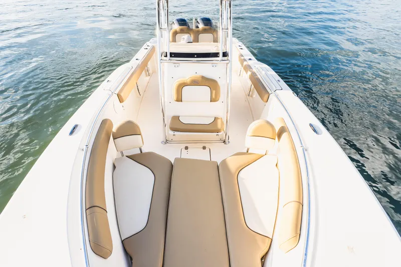 Slide: The Image of 2018 Key West 244 Center Console boat interior with tan seating on calm water. - 17