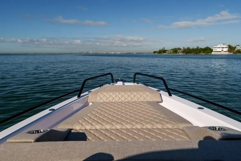 Slide: The Image of Bow view of 2026 Axopar 37 XC Cross Cabin on calm waters. - 6
