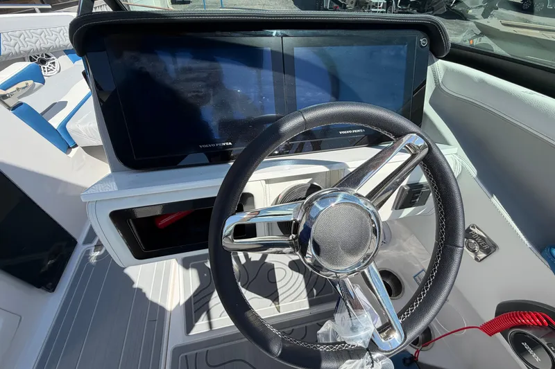 Slide: The Image of Steering wheel and dashboard of 2026 Regal LS6 Surf boat with modern controls. - 12