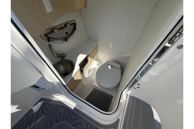 Slide: The Image of 2026 Regal LS6 Surf boat bathroom with compact toilet and sink. - 13