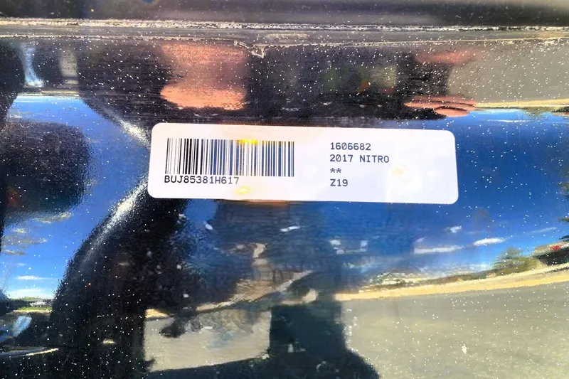 Slide: The Image of Barcode label on a 2017 Nitro Z19 boat hull, reflecting sunlight. - 14