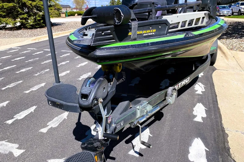 Slide: The Image of 2017 Nitro Z19 boat on trailer, parked on a road with fish-shaped markings. - 2