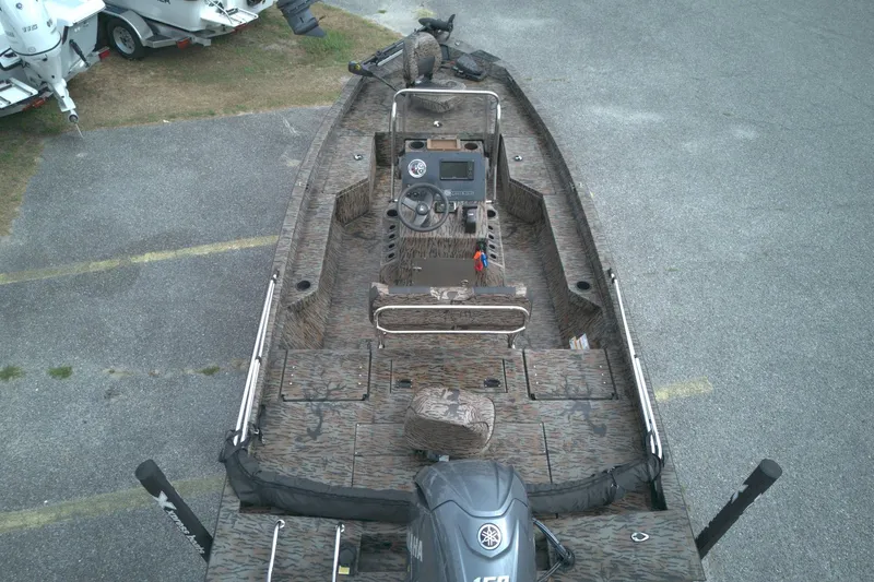 Slide: The Image of 2024 Xpress H20B Bay boat with camouflage design, featuring a Yamaha 150 engine. - 4