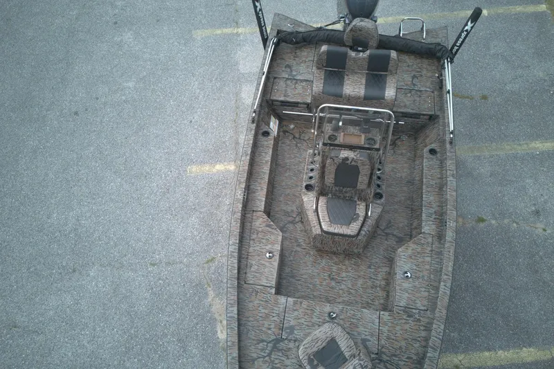 Slide: The Image of 2024 Xpress H20B Bay boat with camouflage design, aerial view. - 8