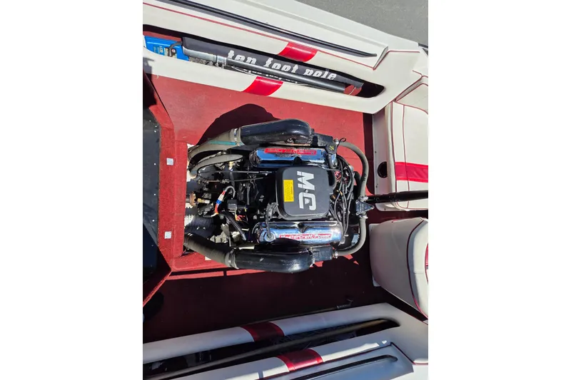 Slide: The Image of 1987 MasterCraft ProStar 190 engine compartment with red interior and visible engine components. - 8
